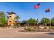 Community center exterior showing modern architecture, desert landscaping, and the American and Arizona flags at 12603 W Blackstone Ln, Peoria, AZ 85383