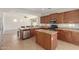 This kitchen features an island with bar seating, stainless steel appliances, granite countertops, and a dishwasher at 12603 W Blackstone Ln, Peoria, AZ 85383