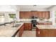 This spacious kitchen features granite countertops, a dishwasher, an island with bar seating and stainless steel appliances at 12603 W Blackstone Ln, Peoria, AZ 85383