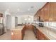 This kitchen features stainless steel appliances, granite countertops, a dishwasher, and an island with bar seating at 12603 W Blackstone Ln, Peoria, AZ 85383