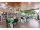 Library features a stone accent wall, bookshelves, tables, and large windows with views of greenery at 12603 W Blackstone Ln, Peoria, AZ 85383