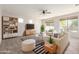 Bright living room with a ceiling fan, plush seating, and abundant natural light at 12603 W Blackstone Ln, Peoria, AZ 85383