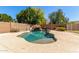 Inviting backyard pool features a rock waterfall, mature trees, and plenty of space for outdoor entertaining at 12603 W Blackstone Ln, Peoria, AZ 85383