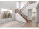 Bright entryway featuring staircase with wood and black wrought iron at 12603 W Blackstone Ln, Peoria, AZ 85383