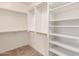 Spacious walk-in closet with white shelving and ample hanging space for organized storage at 12603 W Blackstone Ln, Peoria, AZ 85383