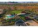 Aerial view of the community showcasing a pool, tennis courts, clubhouse, and other amenities at 13055 W Cliffrose Rd, Peoria, AZ 85383