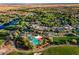 Beautiful aerial view of the property featuring pool, clubhouse, tennis courts, and lush landscaping at 13055 W Cliffrose Rd, Peoria, AZ 85383