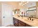 Bright bathroom features a double sink vanity, large mirror, and neutral color palette at 13055 W Cliffrose Rd, Peoria, AZ 85383