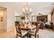 Dining room with decorative chandelier open to the kitchen and living room at 13055 W Cliffrose Rd, Peoria, AZ 85383