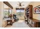 Inviting home office with a massage chair, built-in shelving, and large windows offering ample natural light at 13055 W Cliffrose Rd, Peoria, AZ 85383