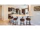 Kitchen with barstool seating at the extended counter, stainless steel appliances, and neutral color scheme at 13055 W Cliffrose Rd, Peoria, AZ 85383