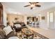 Inviting living room with a comfortable leather sofa, decorative rug, and open access to the kitchen at 13055 W Cliffrose Rd, Peoria, AZ 85383