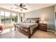 Serene main bedroom featuring a decorative bed frame, bedside lamps, and abundant natural light at 13055 W Cliffrose Rd, Peoria, AZ 85383