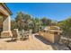 Outdoor kitchen with a stainless steel BBQ, counter space, and patio dining set at 13055 W Cliffrose Rd, Peoria, AZ 85383