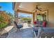 Covered outdoor patio featuring a ceiling fan, comfortable seating, and dining area at 13055 W Cliffrose Rd, Peoria, AZ 85383