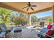 Inviting covered patio with comfortable seating and lush landscaping offering a relaxed outdoor space at 13055 W Cliffrose Rd, Peoria, AZ 85383