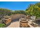 Cozy patio with brick flooring, chairs, table, and wall with vegetation for privacy and a relaxing atmosphere at 13055 W Cliffrose Rd, Peoria, AZ 85383