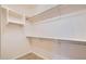 Empty walk-in closet with white shelving and metal hanging bars, offering ample storage at 13055 W Cliffrose Rd, Peoria, AZ 85383