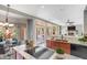 Modern kitchen with stainless steel appliances, granite countertops, and an open floor plan to the living room at 1334 E Voltaire Ave, Phoenix, AZ 85022