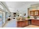 Bright, open kitchen featuring sleek countertops, cabinetry, and an open layout to the living room with fireplace at 1334 E Voltaire Ave, Phoenix, AZ 85022