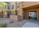 Building 5 entrance featuring well maintained rock garden and shade trees at 14950 W Mountain View Blvd # 5107, Surprise, AZ 85374