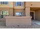 Beige stucco condo building with a small rock garden in front of the entrance at 14950 W Mountain View Blvd # 5107, Surprise, AZ 85374