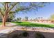 Scenic view of landscaped grounds with mature trees and green grass at 14950 W Mountain View Blvd # 5107, Surprise, AZ 85374