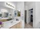 Bright bathroom with a double vanity, large mirror, and well-organized storage at 15252 N 100Th St # 2141, Scottsdale, AZ 85260