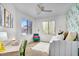 Bright bedroom featuring a daybed, desk, and vibrant cactus-themed decor and wallpaper accent wall at 15252 N 100Th St # 2141, Scottsdale, AZ 85260