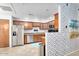 Well-lit kitchen featuring wood cabinets, stainless steel appliances, and attractive backsplash at 15252 N 100Th St # 2141, Scottsdale, AZ 85260