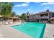 Community pool with lounge chairs, cabana, and well-maintained landscaping against a residential backdrop at 15252 N 100Th St # 2141, Scottsdale, AZ 85260