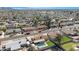 Expansive aerial view of a well-maintained neighborhood with lush greenery and blue swimming pools under a clear sky at 1604 W Kerry Ln, Phoenix, AZ 85027