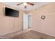 This bedroom features carpeted floors, ceiling fan, and a television mounted on the wall at 1604 W Kerry Ln, Phoenix, AZ 85027