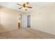 Bright carpeted bedroom with ceiling fan, and access to the ensuite bathroom at 1604 W Kerry Ln, Phoenix, AZ 85027