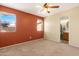 Spacious carpeted bedroom with ceiling fan, windows, and ensuite bathroom at 1604 W Kerry Ln, Phoenix, AZ 85027