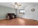 Bright living room with wood floors, a ceiling fan and a view of the front yard at 1604 W Kerry Ln, Phoenix, AZ 85027