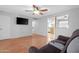 Bright living room with wood floors, a ceiling fan and a view of the kitchen at 1604 W Kerry Ln, Phoenix, AZ 85027