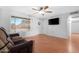 Bright living room with wood floors, a ceiling fan and a view of the front yard at 1604 W Kerry Ln, Phoenix, AZ 85027