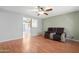 Bright living room with wood floors, a ceiling fan and a view of the doorway at 1604 W Kerry Ln, Phoenix, AZ 85027