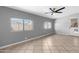 Bright living space with tiled floor, ceiling fan, and natural light from large windows at 1604 W Kerry Ln, Phoenix, AZ 85027