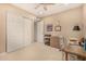 Cozy bedroom featuring neutral walls, desk, built-in storage, and en-suite bathroom access at 16657 E Gunsight Dr # 181, Fountain Hills, AZ 85268