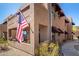 Attractive exterior view of a multistory condo with a private patio and patriotic American flag at 16657 E Gunsight Dr # 181, Fountain Hills, AZ 85268