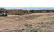 New home construction site with partial frame and supplies on desert landscape at 1800 W Caramel Ct, Queen Creek, AZ 85144