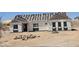 Under construction home with visible exterior and roof tiles ready for installation in a desert landscape at 1800 W Caramel Ct, Queen Creek, AZ 85144