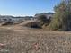 Flat vacant land ready to build with view of desert community and a silver car at 1800 W Caramel Ct, Queen Creek, AZ 85144