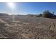 Flat vacant land ready to build with view of desert community under the bright sun at 1800 W Caramel Ct, Queen Creek, AZ 85144