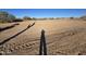 Large vacant lot ready for construction with desert landscape and blue sky at 1800 W Caramel Ct, Queen Creek, AZ 85144