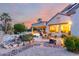 Beautiful backyard space featuring a pool with a rock waterfall and patio dining area at 19793 N Tapestry Ct, Surprise, AZ 85374