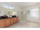 Bathroom featuring double sinks, tiled floors, a glass shower and modern fixtures at 19793 N Tapestry Ct, Surprise, AZ 85374