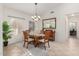 Bright dining room with neutral tones and modern chandelier lighting at 19793 N Tapestry Ct, Surprise, AZ 85374